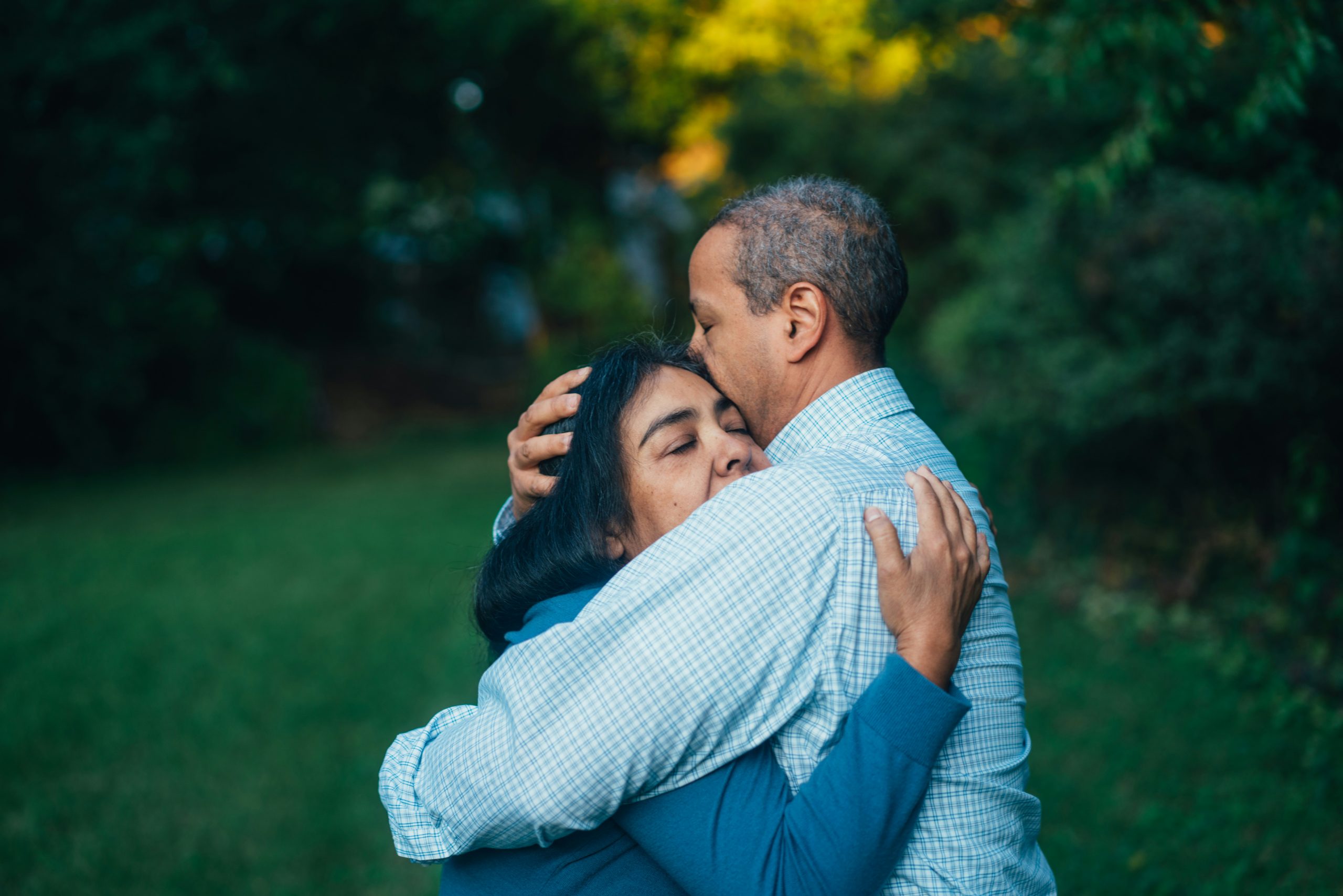 man-hugging-woman-near-trees